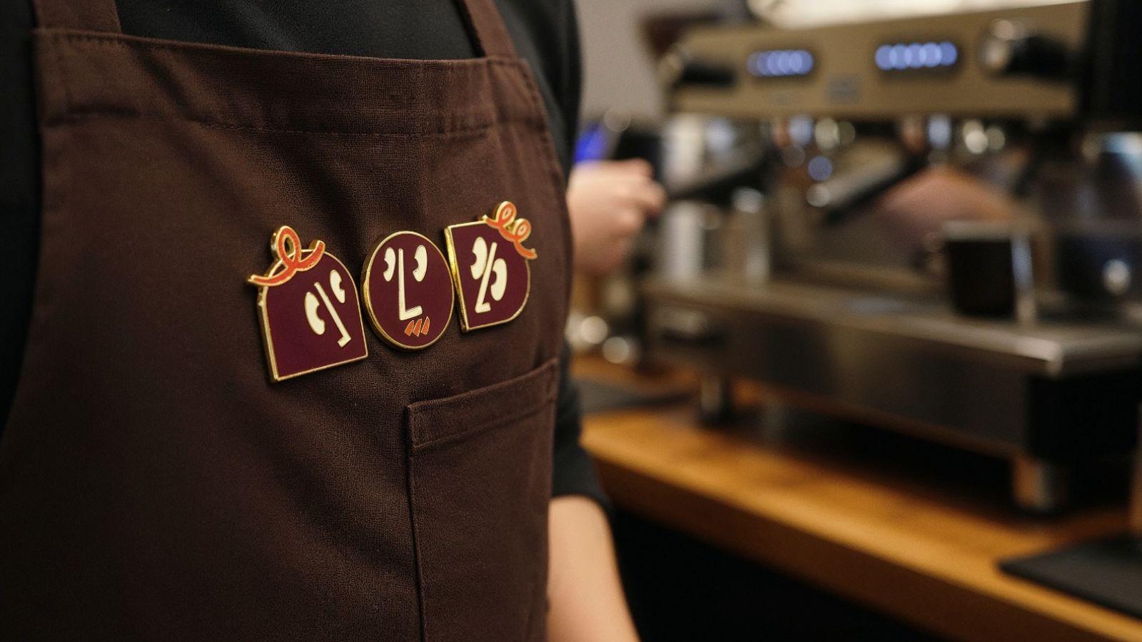 NOD barista apron with crew pins